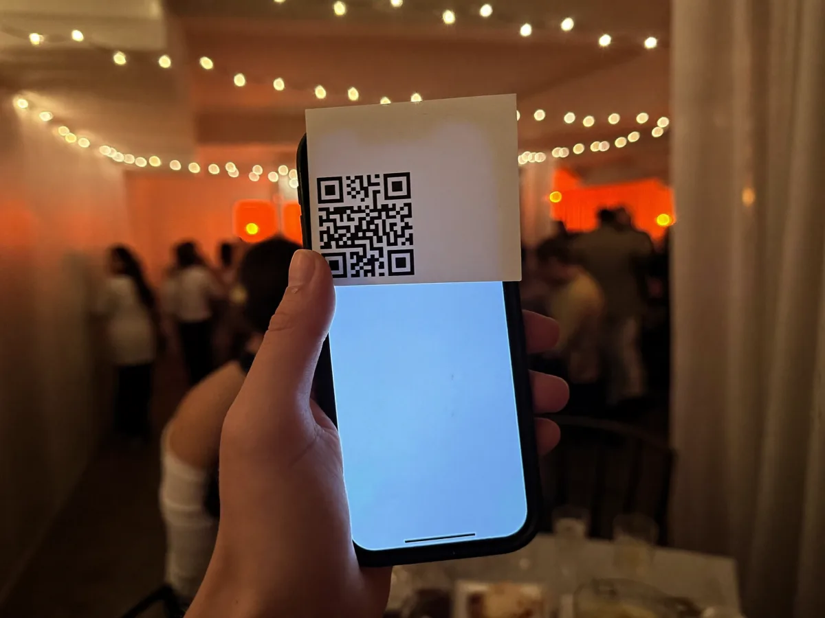 A guest scanning the party's QR code with their phone